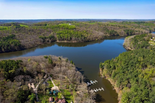 Aerial view of winding river & lush greenery, offering a serene natural backdrop
