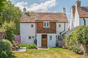 A two-story house with a white exterior and a red-tiled roof. - Charming West Wittering Cottage – Cosy Village Retreat, Pet Friendly (West Wittering)