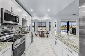Fridge, microwave, oven, stovetop - Luxury Coastal Living with Water Views, Pool & Spa (Cape Coral)