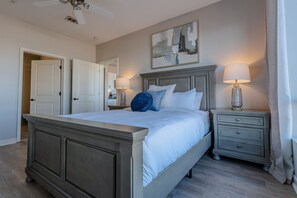 A bedroom with a bed, bedside tables, a ceiling fan, and a painting on the wall. - Luxurious Downtown High floor Corner-2bd2bth-#420- Parking included (Nashville)