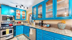 A kitchen with blue cabinets, stainless steel appliances, and a granite countertop. - Redwood Loft - 2 Minutes from Sequoia National Park (Three Rivers)