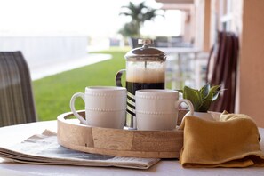 Drink your morning coffee on the patio - Ground‑Floor Patio Walkout W/ Steps to the Heated Pool & Private Beach Access🌴 (Cocoa Beach)