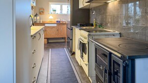 A modern kitchen with a central island, built-in oven, and a stove. - 2 bedroom gorgeous home in Borgholm (Borgholm)
