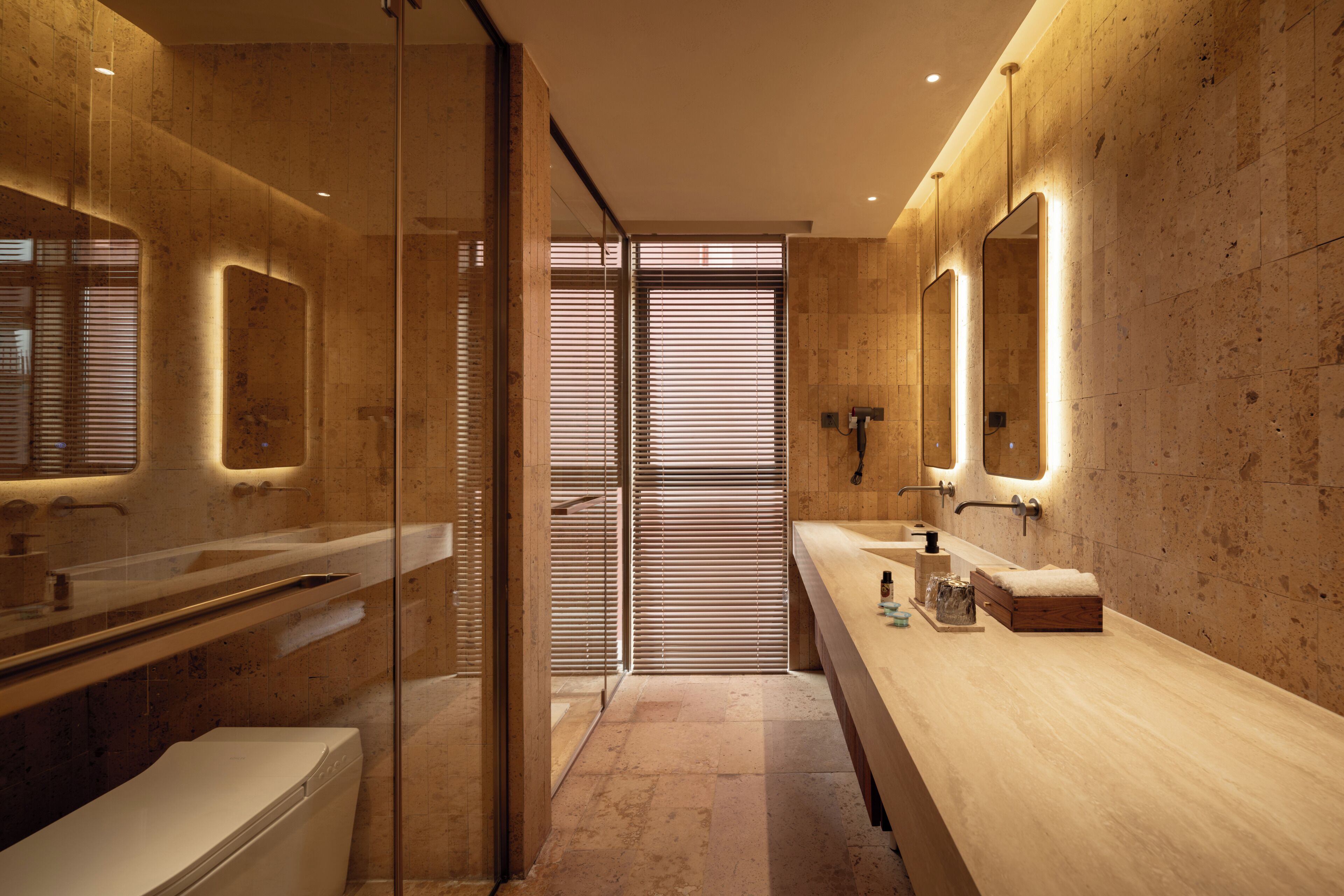 A modern bathroom with a glass shower enclosure, a double sink vanity, and a large mirror.