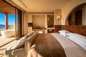 A hotel room with a bed, a sofa, a bathroom, and a view of the outdoors. - Dayoo Hotel Resort (Dali)
