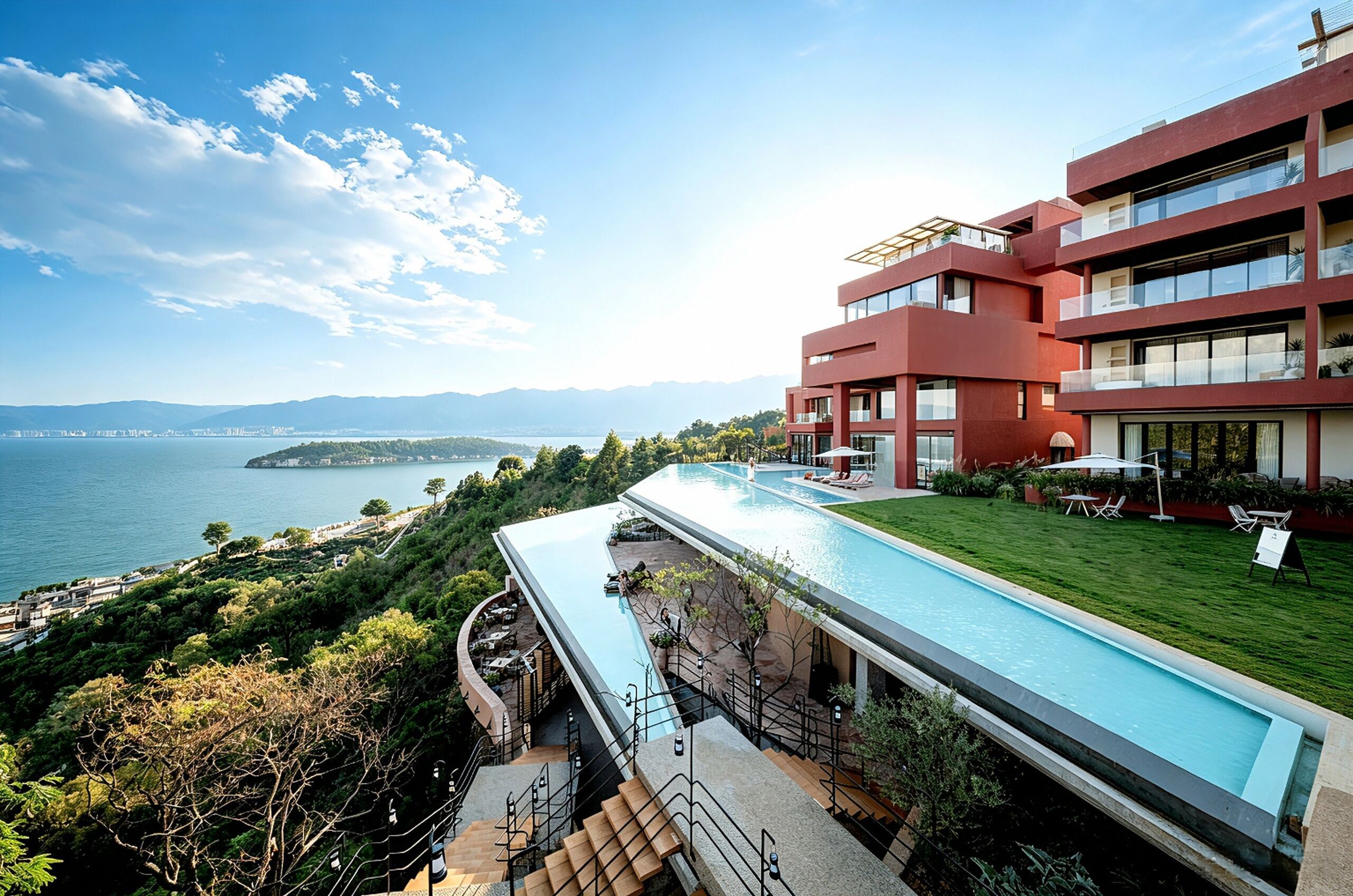 Un hotel moderno con piscina y vistas a un paisaje costero.