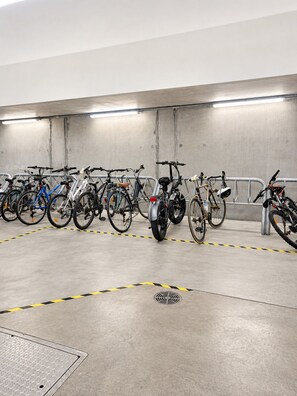 A parking garage with bicycles secured to metal racks. - Koala Cove on Rundle-Effortless Adelaide City Stay (Adelaide)