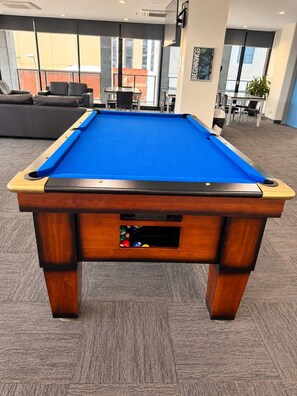 A pool table with a blue felt surface, a built-in ball rack, and a wooden frame. - Koala Cove on Rundle-Effortless Adelaide City Stay (Adelaide)