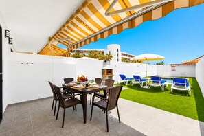 A patio with a dining table, chairs, a grill, and a pool area with lounge chairs. - Fabulous Duplex C8 with Private Pool (Adeje)