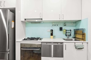 Fridge, microwave, oven, stovetop - Ground Floor One-Bed with Courtyard Access (Strathfield)