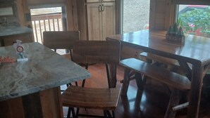 A wooden interior with a dining table, chairs, and a kitchen area. - Beautiful Cabin Perfect For Your Family Gathering in the North GA Mountains (Mineral Bluff)