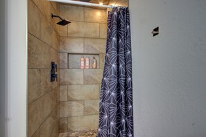 Een douche, handdoeken, zeep, toiletpapier