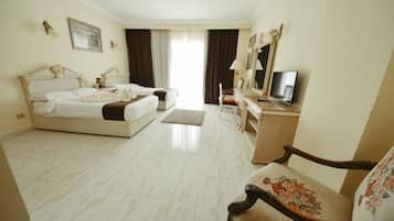 A hotel room with two beds, a television, a dresser, and a chair.
