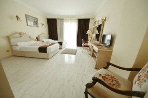 A hotel room with two beds, a television, a dresser, and a chair. - Palma Di Sharm Resort (Sharm El Sheikh)