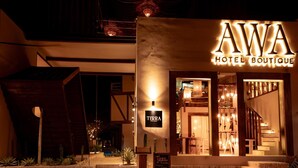 A hotel boutique with a sign reading 'AWA HOTEL BOUTIQUE' and a smaller sign for 'TERRA MOLINA.' - Awa Holbox Hotel Boutique (Isla Holbox)