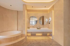 A modern bathroom with a large bathtub, two sinks, and two round mirrors. - Jingdezhen Grand Skylight Hotel (Jingdezhen)