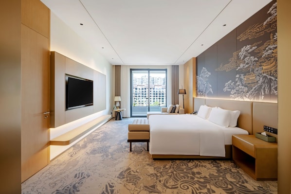 A modern hotel room with a large bed, a flat-screen TV, a large window with a city view, and a decorative wall mural. - Jingdezhen Grand Skylight Hotel (Jingdezhen)