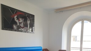 A restaurant with a blue booth seating area, wooden tables, and chairs. - Albergo Flaminia Rooms (Rome)