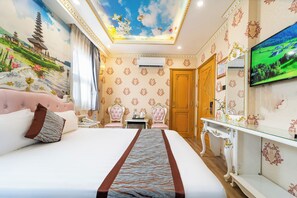 A hotel room with a large bed, a television, a desk, and a wardrobe. - Townhouse District 10 Near Children Hospital 1 (Ho Chi Minh Municipality)