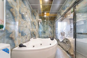A modern bathroom with a large jacuzzi, marble walls, and a glass shower enclosure. - Townhouse District 10 Near Children Hospital 1 (Ho Chi Minh Municipality)
