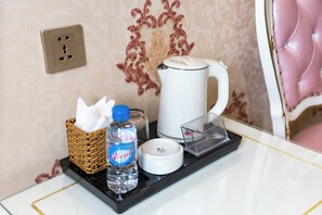 A hotel room's bathroom counter with a water bottle, a tissue box, a coffee maker, and a power outlet. - Townhouse District 10 Near Children Hospital 1 (Ho Chi Minh Municipality)