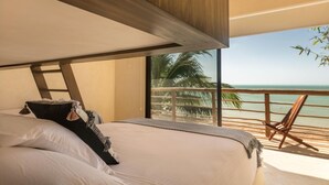A bedroom with a large bed, a view of the ocean, and a balcony with a chair. - Hotel Boutique Casa Muuch Holbox - Solo Adultos (Isla Holbox)