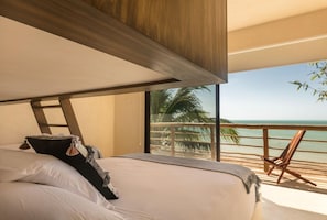A bedroom with a large bed, a view of the ocean, and a balcony with a chair. - Hotel Boutique Casa Muuch Holbox - Solo Adultos (Isla Holbox)