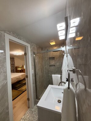 Shower, hair dryer, towels, toilet paper