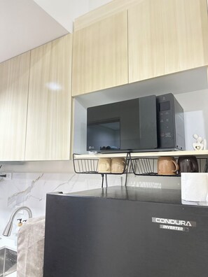 Fridge, microwave, stovetop, electric kettle - Cozy, Spacious 1-bedroom Condo in Novaliches, Perfect for Staycations & Creators (Quezon City)
