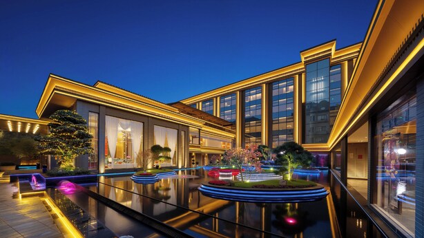 A modern hotel with a reflective pool, well-lit exterior, and landscaped gardens. - Power Stone Hotel Chengdu Kuanzhai Alley Branch (Chengdu)