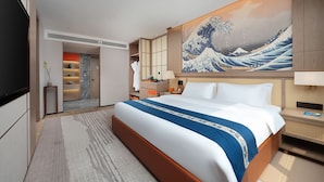 A modern hotel room with a large bed, a painting of a wave, a walk-in closet, and a bathroom with a shower and toilet. - Power Stone Hotel Chengdu Kuanzhai Alley Branch (Chengdu)