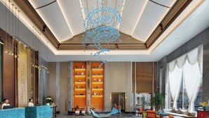 A spacious lobby with a reception desk, seating area, and a decorative ceiling sculpture. - Power Stone Hotel Chengdu Kuanzhai Alley Branch (Chengdu)