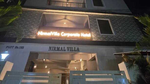 A hotel entrance with a sign reading "Nirmal Villa Corporate Hotel" and "Plot No. 122". - Fabhotel Nirmalvilla Corporate (Hyderabad)