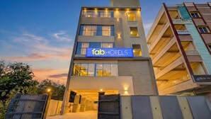 A modern hotel building with a prominent sign reading "Tab Hotels".
