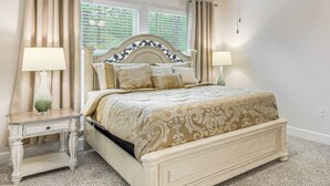 A bedroom with a bed, two bedside tables, a nightstand, a ceiling fan, and a window with curtains. - 8 Mi to Dtwn Pensacola: Modern Escape w/ Patio! (Pensacola)