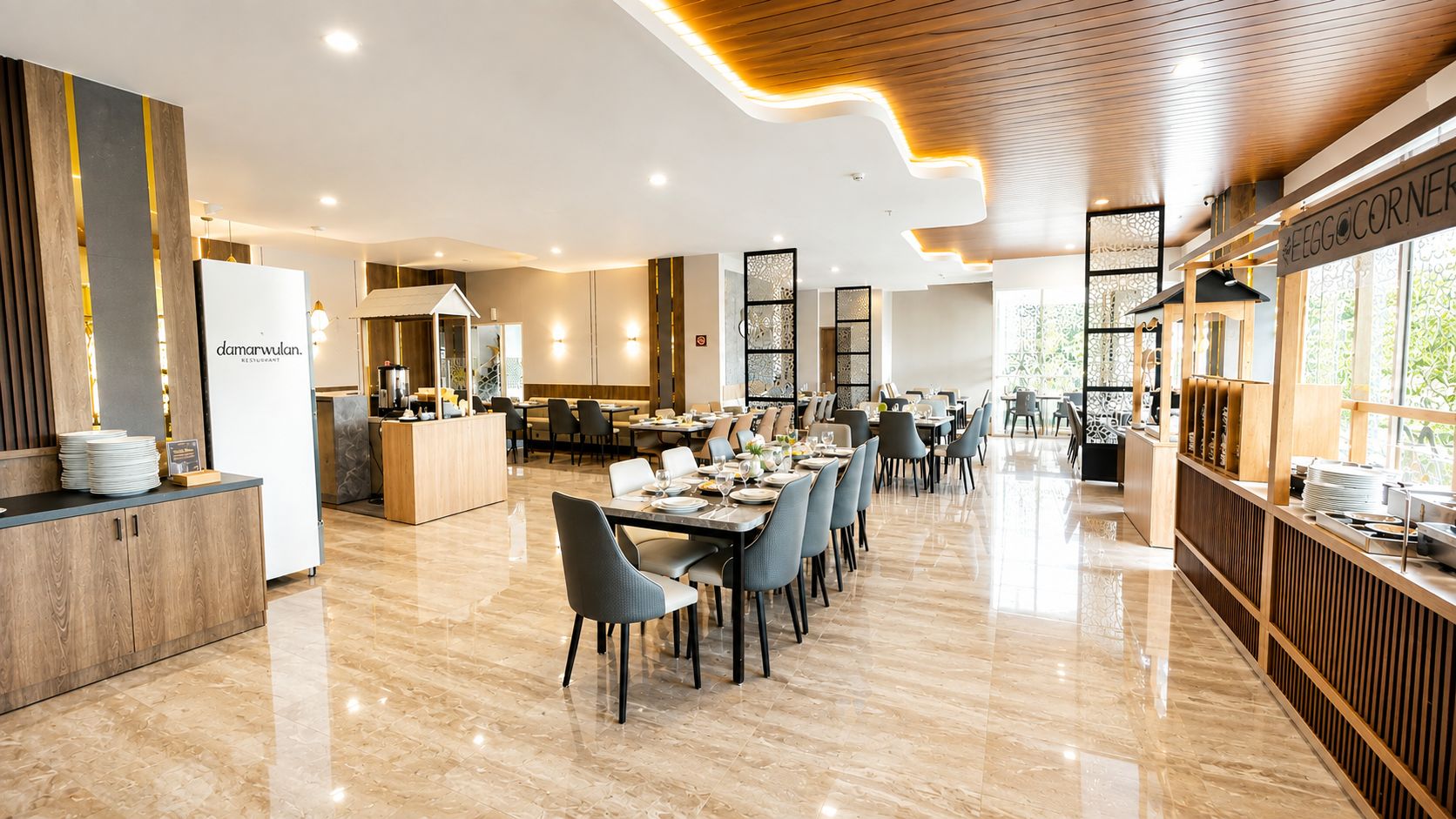 A modern restaurant interior with a long dining area, a counter with a menu, and a kitchen in the background.