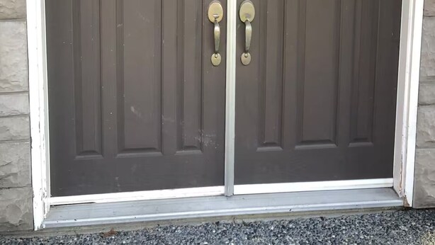A double door with a white frame, set in a stone wall. - Small, renovated, private 1 bedroom bathroom in front of bus stop to downtown. (Vancouver)