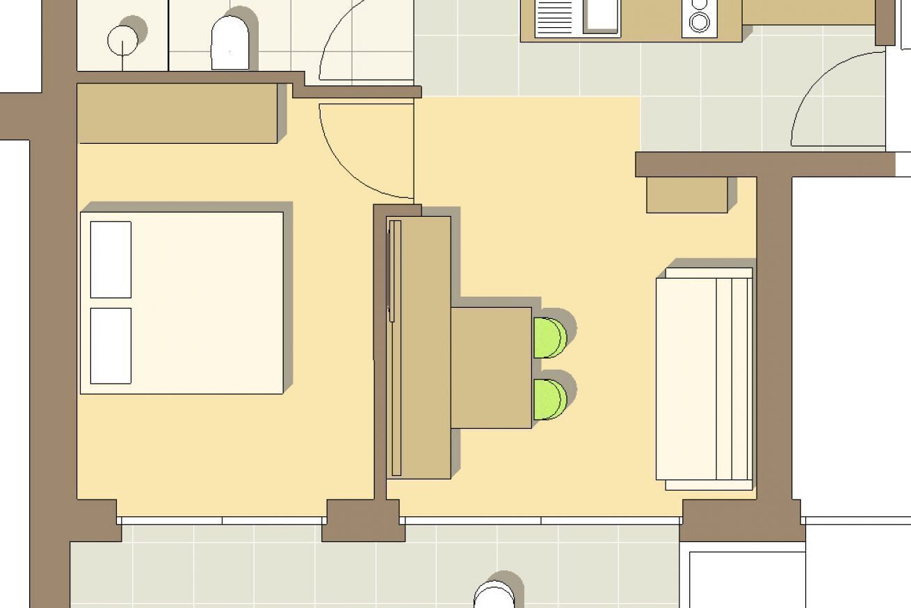 Un plan d’étage d’une chambre d’hôtel comprenant un lit, un bureau, une chaise, une armoire et une salle de bain.