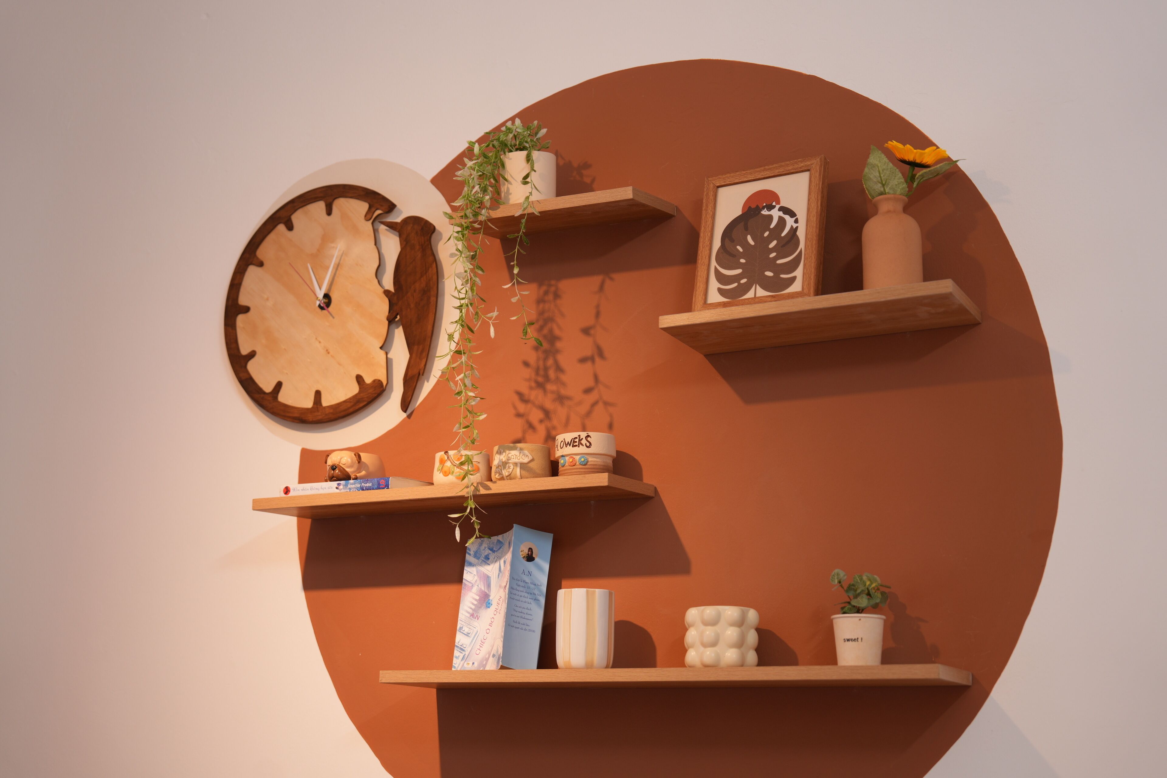 A wall with a clock, shelves with plants, and decorative items.