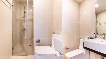 Separate tub and shower, hydromassage showerhead, designer toiletries