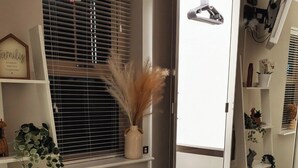 A room with a window, a mirror, and a white wardrobe with a hanging rod. - Canal-side haven, short canal walk to city. Pet Friendly and parking! (Leeds)