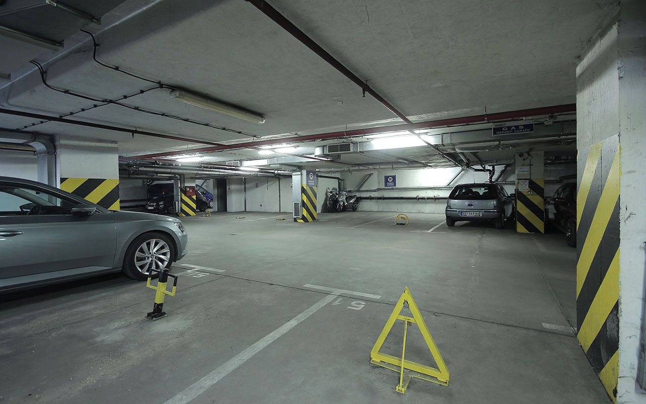 A multi-level underground parking garage with cars parked in designated spaces.