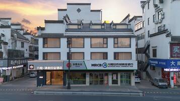 A multi-story building with signage for a bank and a hotel.