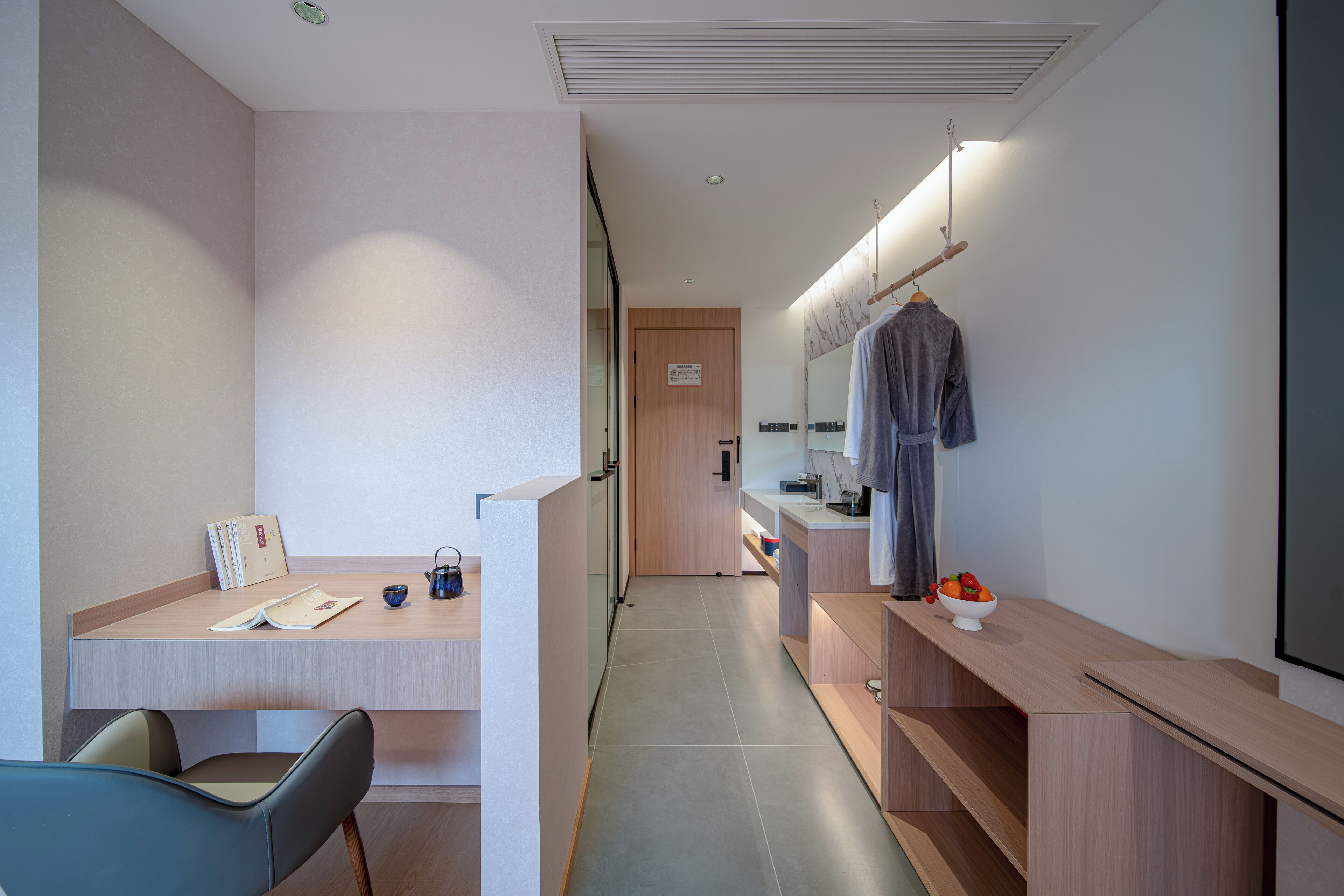 A modern bathroom with a shower, a sink, and a mirror.