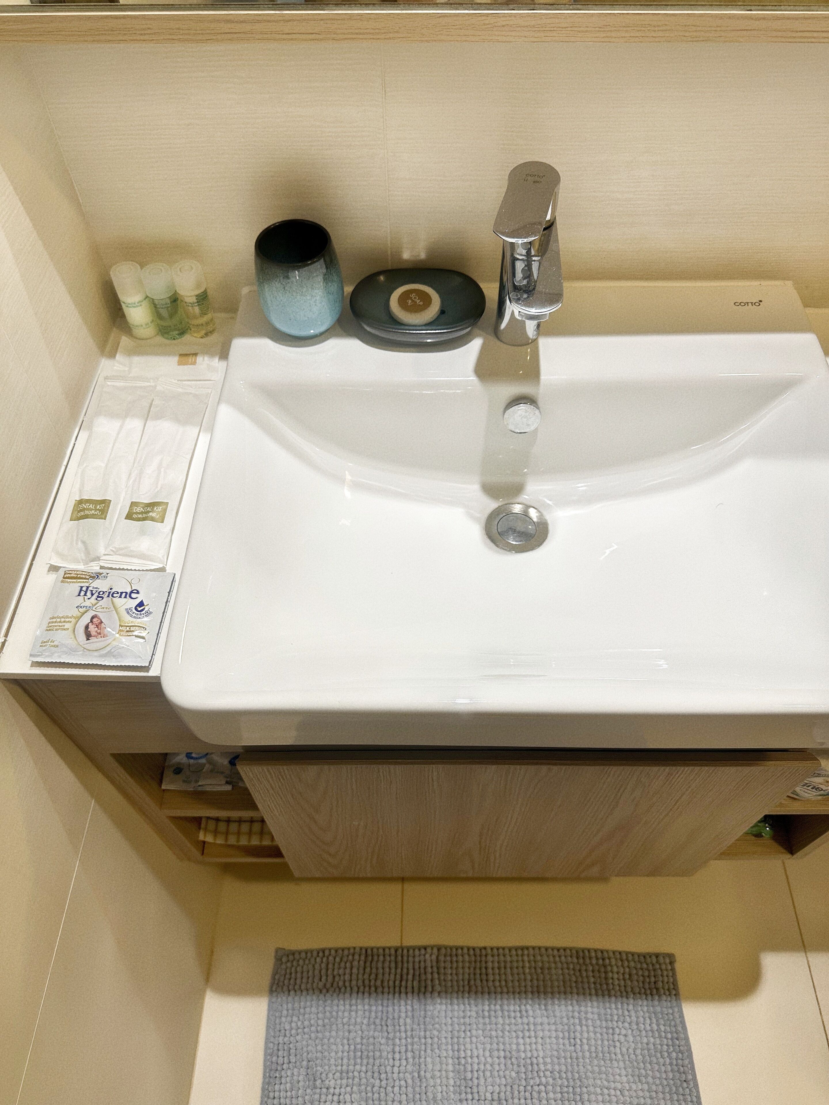 A bathroom sink with toiletries, a soap dish, and a toothbrush holder.