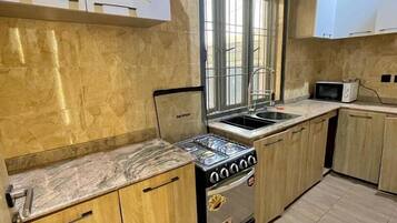 Economy Apartment, Balcony, City View | Private kitchen | Fridge, microwave, oven, stovetop