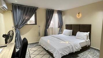 Economy Apartment, Balcony, City View | In-room safe, desk, laptop workspace, blackout drapes