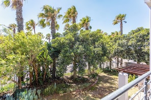 A garden with various trees and a pathway. - Waterstone West A202 by CTHA (Cape Town)