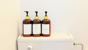 Three brown bottles with yellow pumps on a white toilet tank. - XeroB HOUSE FLOLIA503 (osaka naniwa ward nanbanaka)