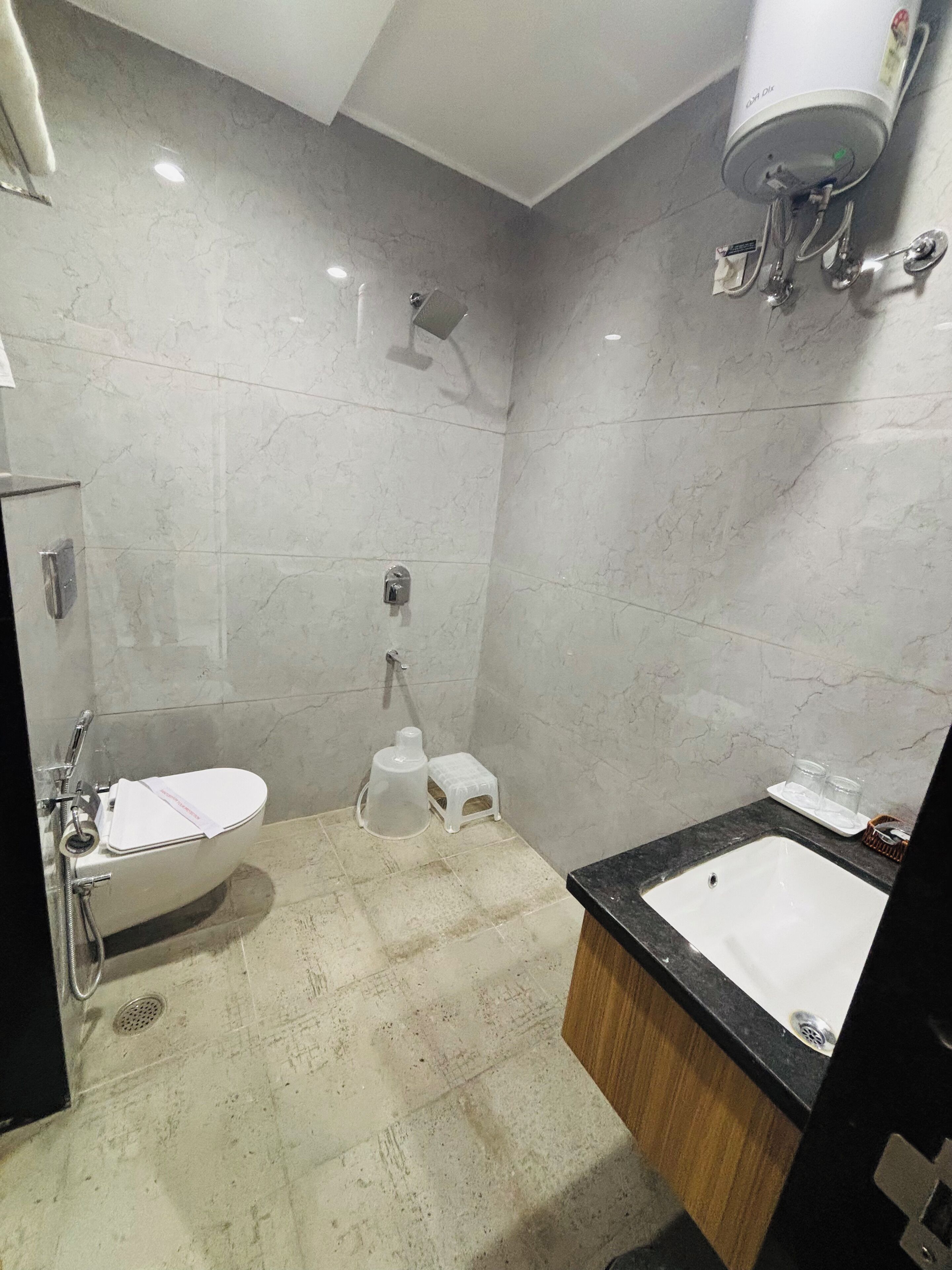 A bathroom with a toilet, sink, and shower.